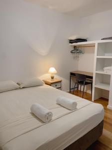 a bedroom with a bed with two towels on it at Prizba Tomas One in Blato