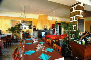 uma sala de jantar com uma mesa longa com guardanapos azuis em Residence I Delfini em Tiuccia