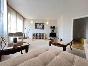 a living room with a couch and a table at Lugano Couples Quiet Apt w Free Street Parking in Sofia