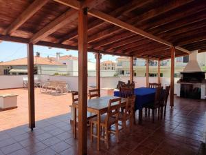 a patio with a table and chairs on a roof at Elite Suites in Afitos