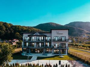an image of a building with mountains in the background at Pensiunea Heaven in Deva