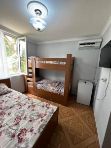 a bedroom with two bunk beds and a window at Saba Guest House in Ureki