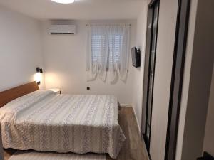 a bedroom with a bed and a window at Casa Bianca Apartman Dramalj in Dramalj +39 photos