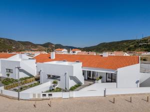 an aerial view of a white house with red roofs at Casa Ingrina in Carrapateira