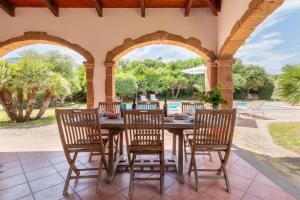 an outdoor dining room with a table and chairs at Agri Resort San Giuliano in Santa Maria la Palma