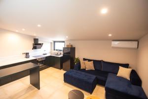 a living room with a couch and a desk at Zafirakis Suites Amaliada in Amalias