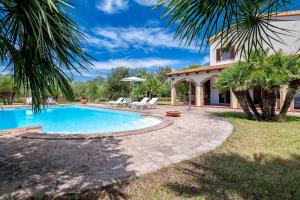 a villa with a swimming pool and a house at Agri Resort San Giuliano in Santa Maria la Palma