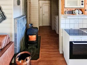 a hallway of a kitchen with a stove at 6 person holiday home in Flatanger in Lauvsnes +14 photos