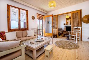 a living room with a couch and a table at Etherio House in Skala Sotiros