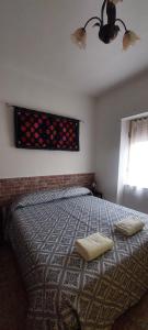 a bedroom with a bed with two pillows and a window at Casa Scirocco Sardegna in San Vito