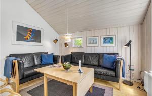 a living room with a couch and a table at Holiday Home Mælkebøttevej Væggerløse Ii in Marielyst