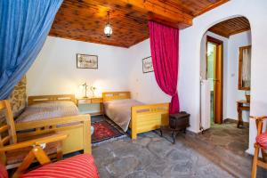 a bedroom with two beds in a room at Etherio House in Skala Sotiros