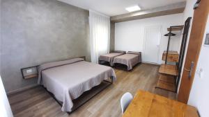 a bedroom with a bed and a table and a chair at Villa Serena in Lido di Jesolo +104 photos
