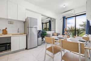 a kitchen and dining room with a table and chairs at Belia by Kozystay - BSD in Tangerang