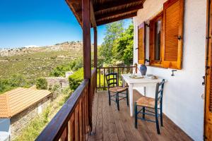 a balcony with a table and chairs and a view at Etherio House in Skala Sotiros