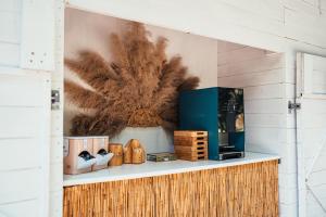 a shelf with a painting on a wall at Glamping Blessed - Adult Only in Best
