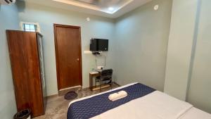 TV a/nebo společenská místnost v ubytování Hotel Abhinanadan + 15 fotografií