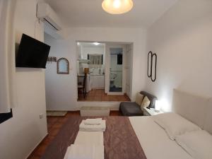 里姆尼奥纳斯Kapetaniou Apartments的一间带床的卧室和一间客厅