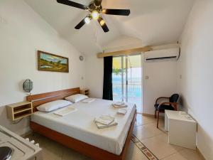 a bedroom with a bed and a ceiling fan at Apartments Nikvik in Budva