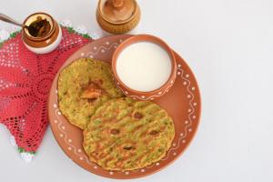 a plate of food with a cup of milk at THE ROYAL VILLA - Noida Sector 70 in Noida