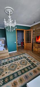 a living room with a chandelier and a rug at LUX-Апартаменты London Style в центре Усть-Каменогорска in Ustʼ-Kamenogorsk