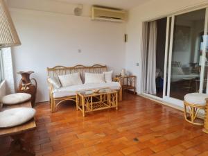 a living room with a couch and a table at Casa dos Arcos in Olhos de Água