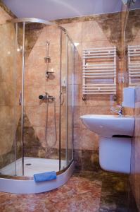 a bathroom with a shower and a sink at Hotel Nidzki in Ruciane-Nida +33 photos