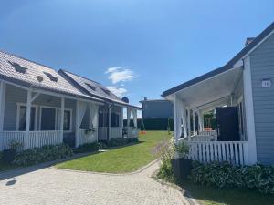 a side view of a house with a driveway at Rewalia in Rewal