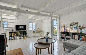 a living room with a couch and a table at Awesome Home In Knebel With Kitchen in Knebel