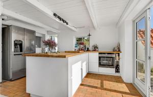 a kitchen with white cabinets and a counter top at Awesome Home In Knebel With Kitchen in Knebel