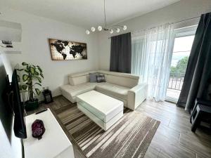 a living room with a couch and a table at Apartment in Dramalj 44160 in Dramalj