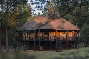 a large house with a thatched roof at Emerald Resort & Casino in Vanderbijlpark