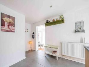a living room with white walls and a tile floor at Eyes Ferienhaus im Nationalpark Eifel in Schleiden