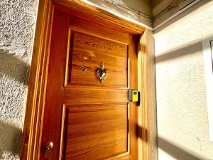 a wooden door with a handle in a room at Maria Apartment Rootsi 9 in Kuressaare