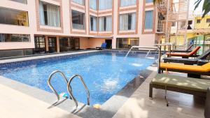 a swimming pool with a fountain in a building at Fortune Select Candolim, Goa - Member ITC Hotels' Group in Candolim