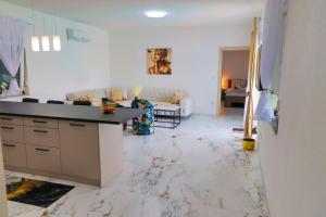 a kitchen and living room with a marble floor at Villa De Luxe Infinity in Bihać