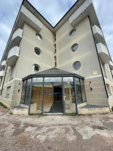 a building with a revolving door in front of it at Le Clairvaux - Proche centre avec 1 place en parking souterrain in Dijon