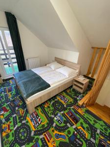 a bedroom with a bed with a race car rug at Vila Niculina in Moieciu de Jos
