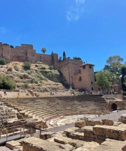 an amphitheatre in front of a large brick building at Premium Historic Center & Parking in Málaga