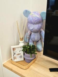 a teddy bear sitting on a desk next to a plant at Cozy Rooftop - Sint-Idesbald in Koksijde