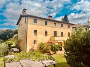 an old house with a garden in front of it at La Casa di Francesca tra le Colline di Lucca in Toscana in Lucca