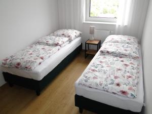 two twin beds in a bedroom with a window at Apartament 46 Belweder Park Nysa in Nysa