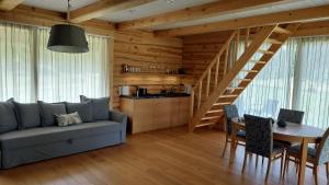 a living room with a couch and a table at Kuuse metsamaja in Saaremaa