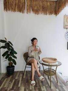 a woman sitting in a chair with a glass of wine at De Chalet in Bangkok +64 photos