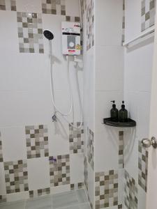 a shower in a bathroom with a shower at De Chalet in Bangkok