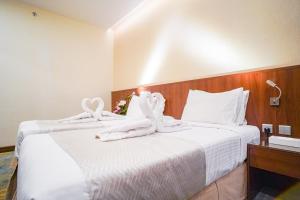 Ένα ή περισσότερα κρεβάτια σε δωμάτιο στο Emaar Elite Hotel