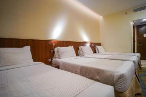 Ένα ή περισσότερα κρεβάτια σε δωμάτιο στο Emaar Elite Hotel