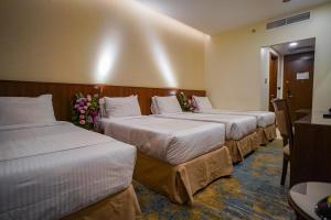 Ένα ή περισσότερα κρεβάτια σε δωμάτιο στο Emaar Elite Hotel