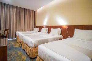 Ένα ή περισσότερα κρεβάτια σε δωμάτιο στο Emaar Elite Hotel