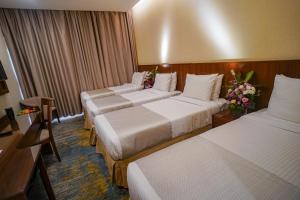Ένα ή περισσότερα κρεβάτια σε δωμάτιο στο Emaar Elite Hotel